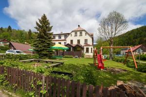 a yard with a house and a playground at Bouda Morava - snídaně v ceně - klidné Krkonoše in Dolni Dvur