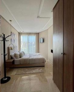 a bedroom with a bed and a large window at Tokyo in Maarif