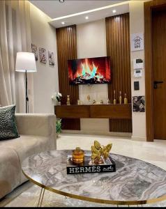 a living room with a couch and a tv at Tokyo in Maarif +2 photos