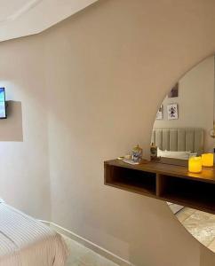 a bedroom with a bed and a mirror on the wall at Tokyo in Maarif