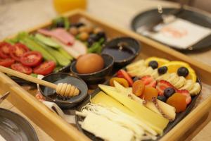 a tray of fruit and vegetables on a table at Lavender Inn Hotel in Arnavutköy