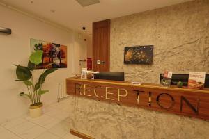 a reception desk with a keep tumor sign in a lobby at Lavender Inn Hotel in Arnavutköy