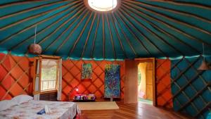 a room with a tent with a bed in it at Ananda Matha YURTA - Vale do Capão in Palmeiras