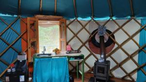 a room with a table in a yurt at Ananda Matha YURTA - Vale do Capão in Palmeiras +4 photos