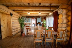 a dining room with a table and chairs at Zrub Kriváň Chalet with Mountain View in Závažná Poruba