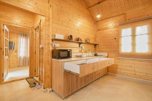 a kitchen with a sink and a microwave at Kahani Cottages Palampur in Paror +19 photos