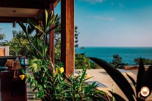 a view of the ocean from a beach house at Coyote, 7BR Ocean View Villa, 2 Pools, Zipolite in Puerto Ángel