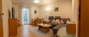 a living room with a couch and a table at Appartementhof Stadler in Pocking