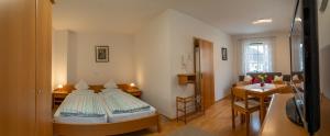 a small room with a bed and a dining room at Appartementhof Stadler in Pocking +81 photos