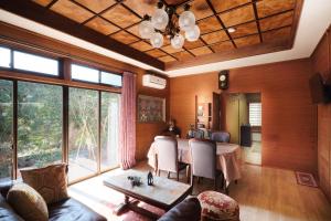 a living room with a table and a large window at nouveau marche ヌーボーマルシェ in Katori