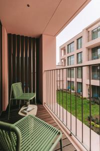 a balcony with a table and chairs and a building at Hotels 705 O'Porto Hotel in Porto