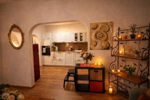 a kitchen with white cabinets and a table with candles at Villa Christina in Kamp-Bornhofen +2 photos