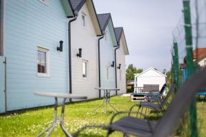 a row of tables and chairs in front of a building at Domki Scandinavia in Rowy