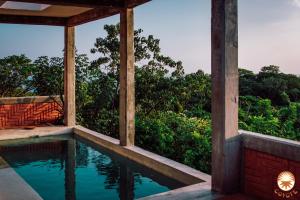 a view from the porch of a house with a swimming pool at Coyote, 7BR Ocean View Villa, 2 Pools, Zipolite in Puerto Ángel