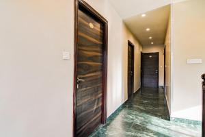 a hallway with a wooden door in a house at Collection O Belgacihia Near Kolkata Railway Station Formerly Beeu Guest House in kolkata