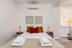 a bedroom with a large white bed with two night stands at Doormans House city center by Homeful Homes in Lisbon