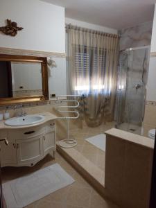 a bathroom with a sink and a shower at Sikelia in Santa Elisabetta +36 photos