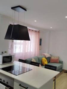 a kitchen with a couch and a table in a room at Pretodomar2 in A Coruña +1 photo