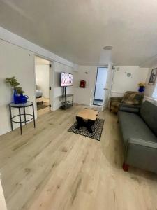 a living room with a couch and a table at Lower Level Luxury in Chicago