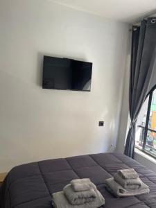a bedroom with a bed and a flat screen tv at Helios in Ioannina