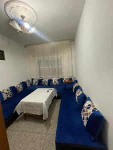 a room with a blue couch and a bed at Appartement Belle vue 3 Meknès in Meknès