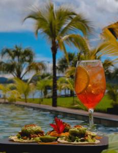 a drink sitting on a table next to a pool at El Sauce Resort in Sauce