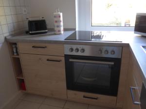 a kitchen with a stove and a counter top at Bergidylle in Kurort Oberwiesenthal