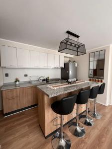a kitchen with a large island with bar stools at Lindo Brisas in Talcahuano