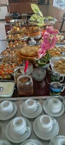 a buffet with a lot of food on a table at Hotel e Pousada França in Manhã +8 photos