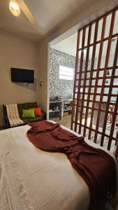 a bedroom with a large bed and a tv on the wall at Kitinet Cunha in Cunha