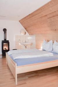a bedroom with a bed and a fireplace at Biobauernhof Gegg in Schwanberg