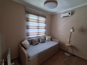 a bedroom with a bed with pillows and a window at Sol de Infantes in Villanueva de los Infantes