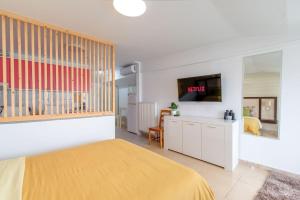 a bedroom with a bed and a tv in it at Lakeview Sunset Kastoria in Kastoria