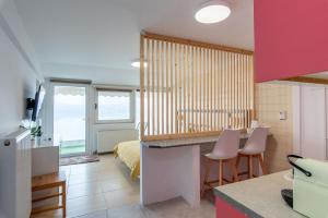 a kitchen and living room with a room with a bed at Lakeview Sunset Kastoria in Kastoria