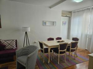 a dining room table and chairs in a living room at Premium Square Apartment in Skopje
