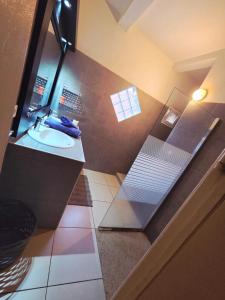 a small bathroom with a sink and a shower at Casa mia in Saly Portudal