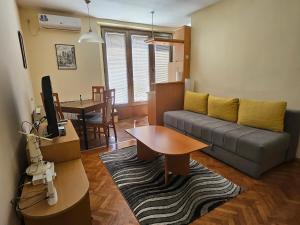 a living room with a couch and a table at Premium Square Apartment in Skopje