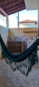 a hammock in the middle of a room at Kitinet Cunha in Cunha