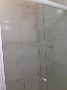 a shower with a glass door in a bathroom at Hospedagem Setúbal in Recife