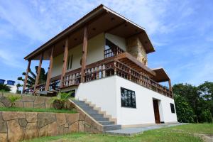 a house with a balcony on top of a hill at Angatu Amazon Jungle Lodge in Iranduba