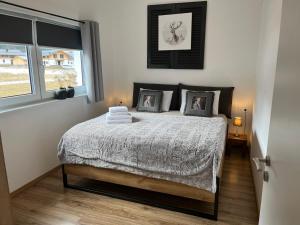 a bedroom with a bed with two pillows on it at Appartements Bergliebe in Bichlbach