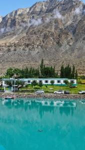 a large body of water in front of a mountain at Ameer lodge in Hunza Valley