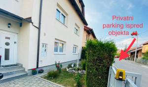 a white house with a red arrow pointing to a building at Apartman Sweet Garden K&A in Zagreb +28 photos