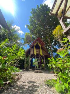 a gazebo in the middle of a garden at Paraisurf colombia in Nuquí