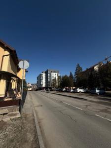 an empty street with cars parked on the side of the road at Luxury Apartaments 3 in Truskavets