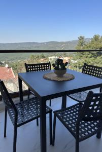 a blue table and chairs on a balcony at Panorama Serenity Suites in Thessaloniki