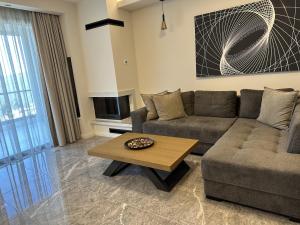 a living room with a couch and a coffee table at Panorama Serenity Suites in Thessaloniki