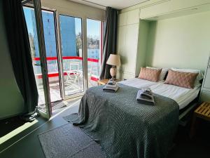 a bedroom with a bed and a large window at Modern Living, Luxe Studio Zurich in Zurich