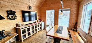 a wooden room with a wooden table in a cabin at Arctic Getaway Sørvågen - King Crab Welcome Gift in Sørvågen