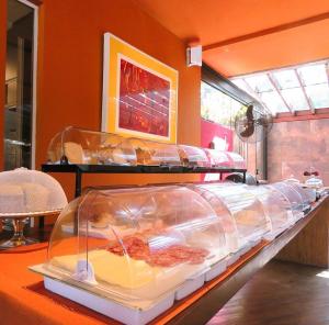 a buffet with two trays of food in a room at Pousada Armação de Camburi in Camburi